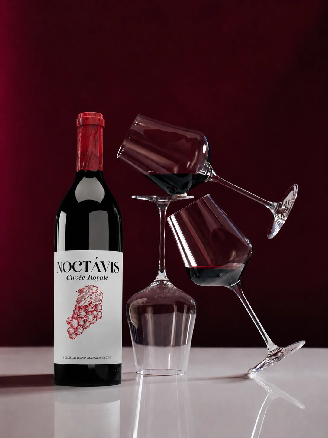 Noctavis bottle beside a sculptural arrangement of wine glasses on a deep red background